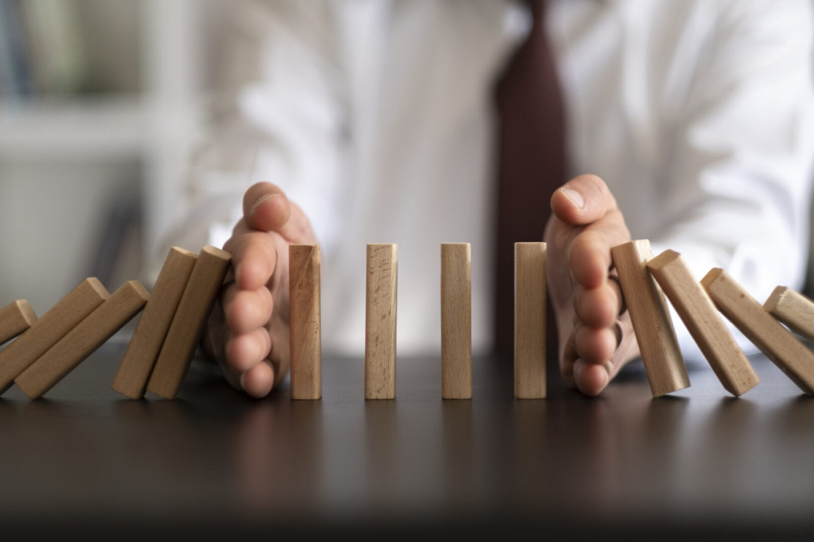 A person is holding their hands over the blocks.