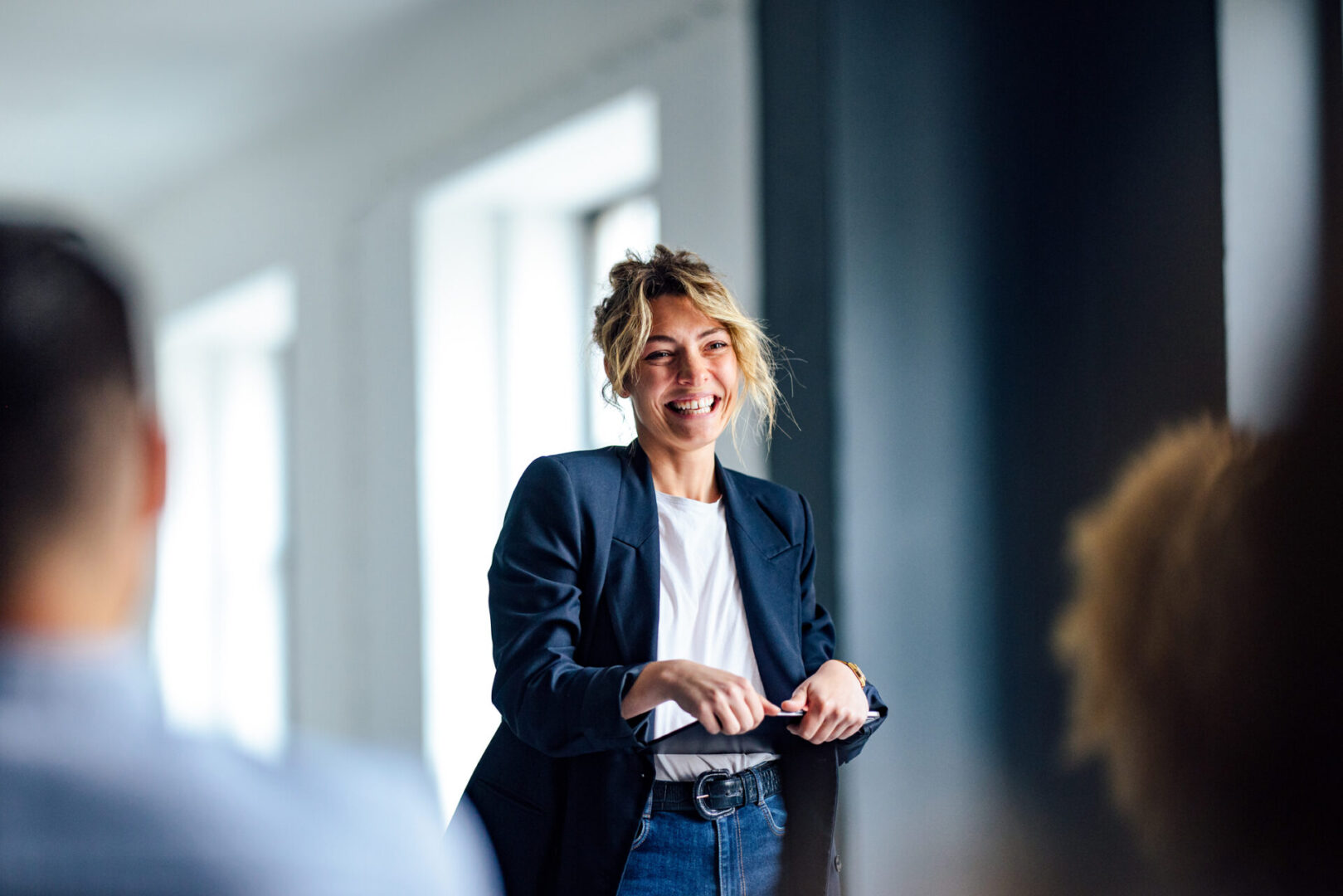 A woman in a black jacket and blue jeans.